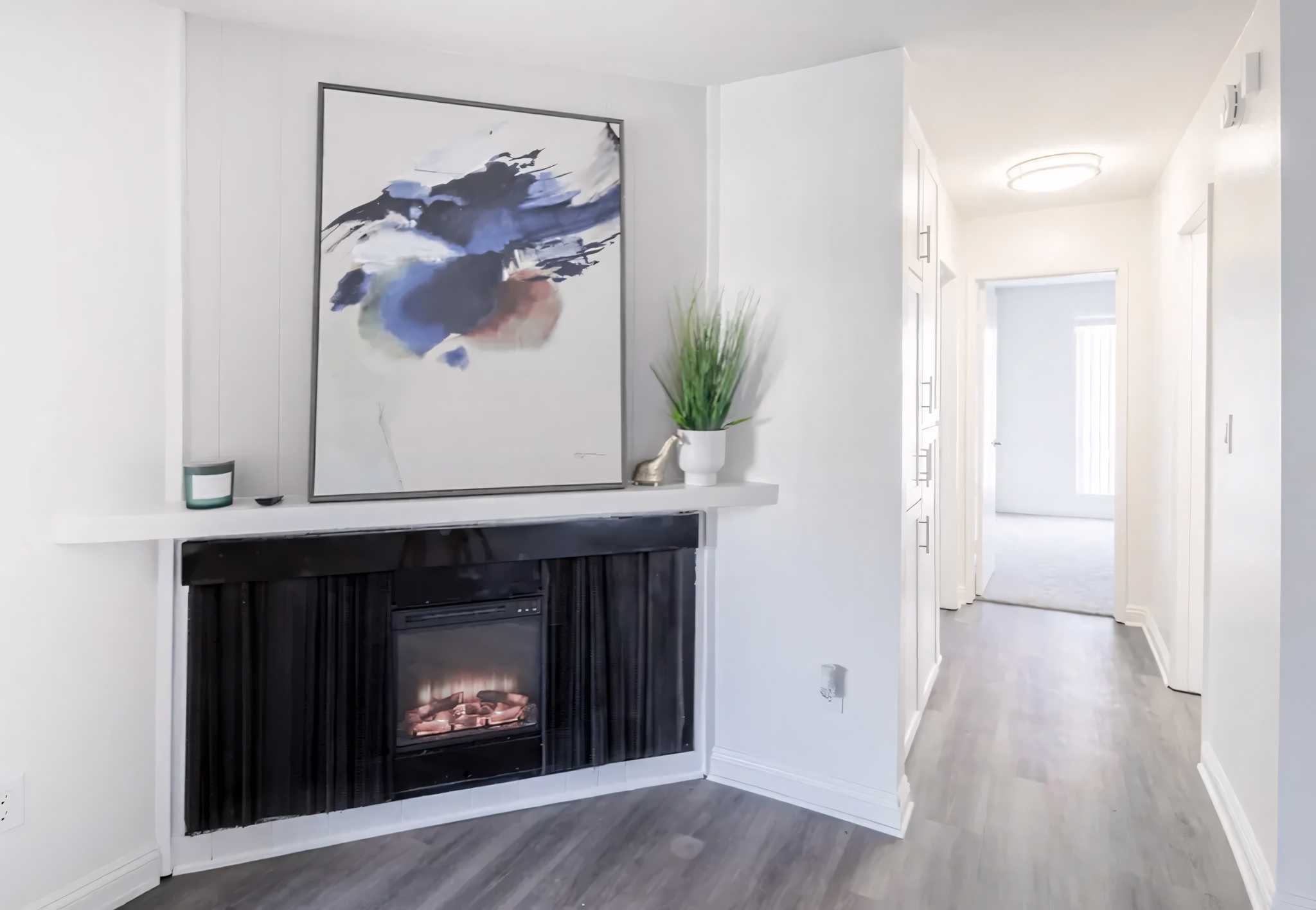 Artesia Crossings apartments livingroom fireplace painting bright hallway